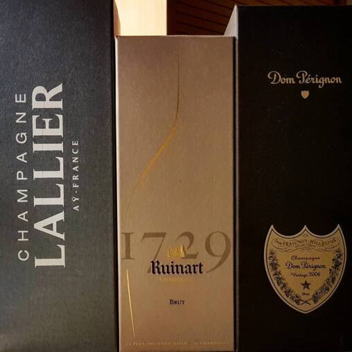 Three champagne presentation boxes side by side, Lallier, Ruinart 1729 Brut and Dom Pérignon Vintage 2006
